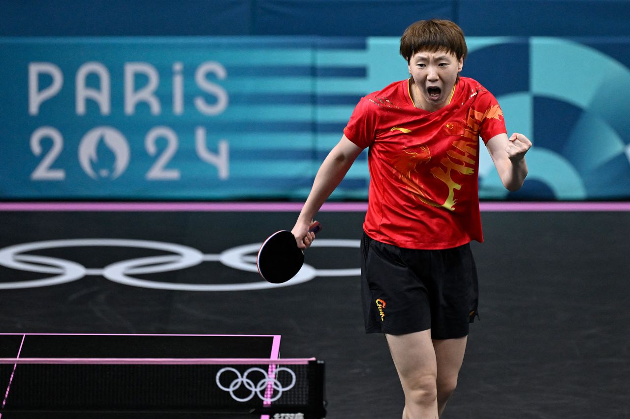 China's Wang Manyu celebrates after winning the women's table tennis team gold medal match against Japan on August 10.