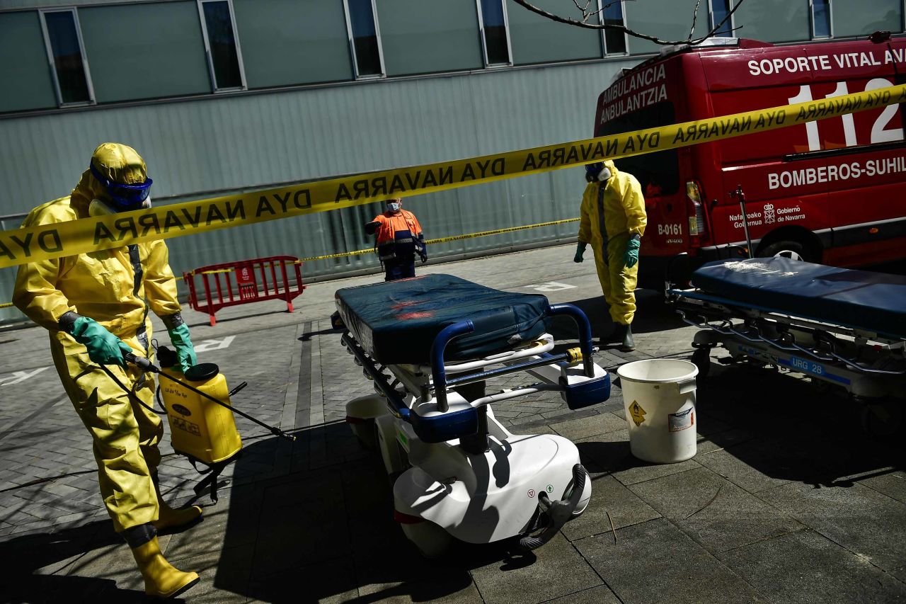 Volunteer workers from a regional search and rescue crew disinfect a stretcher in Pamplona, Spain, on March 26.