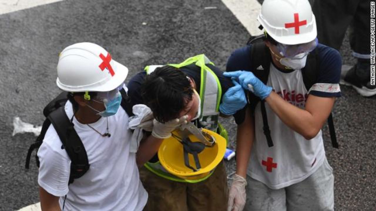 A protester is helped by medical volunteers after being hit with tear gas fired by police during the protests on June 12 in Hong Kong.