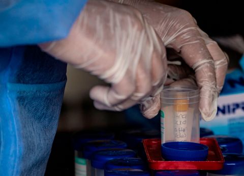 A health worker places a tube with a swab sample for a Covid-19 coronavirus test among others in Bogota on December 21, 2020. 