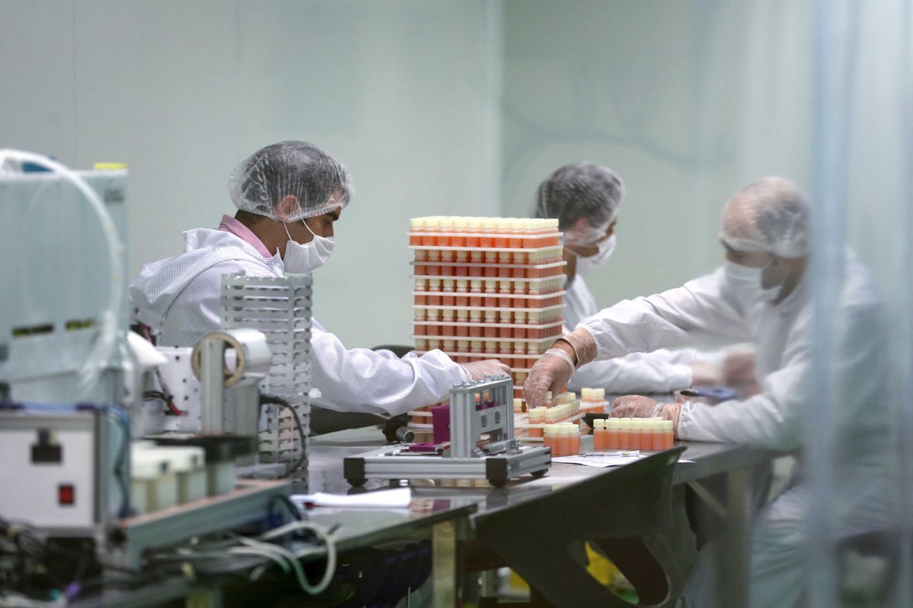 Medical staff work on the production of COVID-19 testing kits in Karaj, Iran, on April 11.