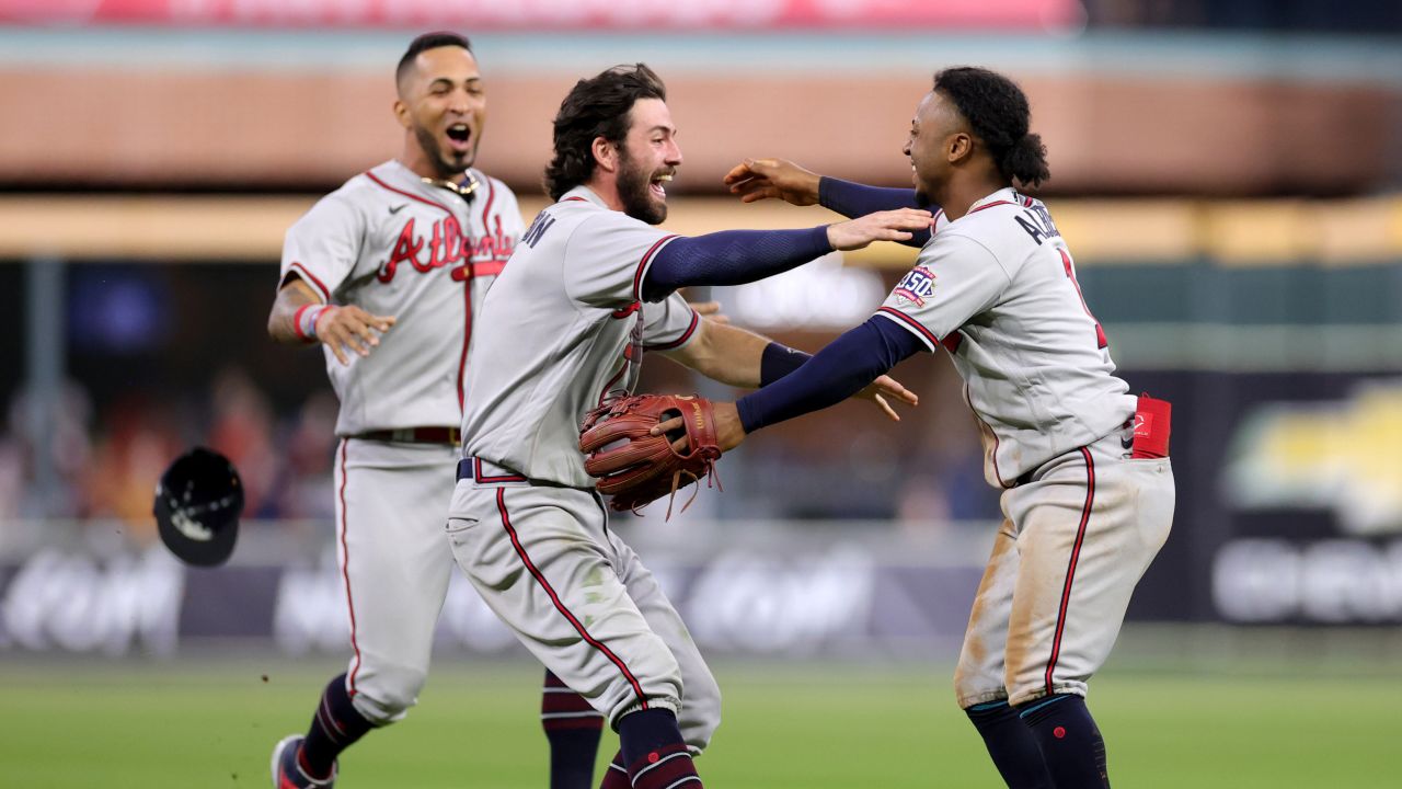 Dansby Swanson, left, and Ozzie Albies, right, of the Braves celebrate the team's victory against the Astros in Game 6 to win the 2021 World Series.