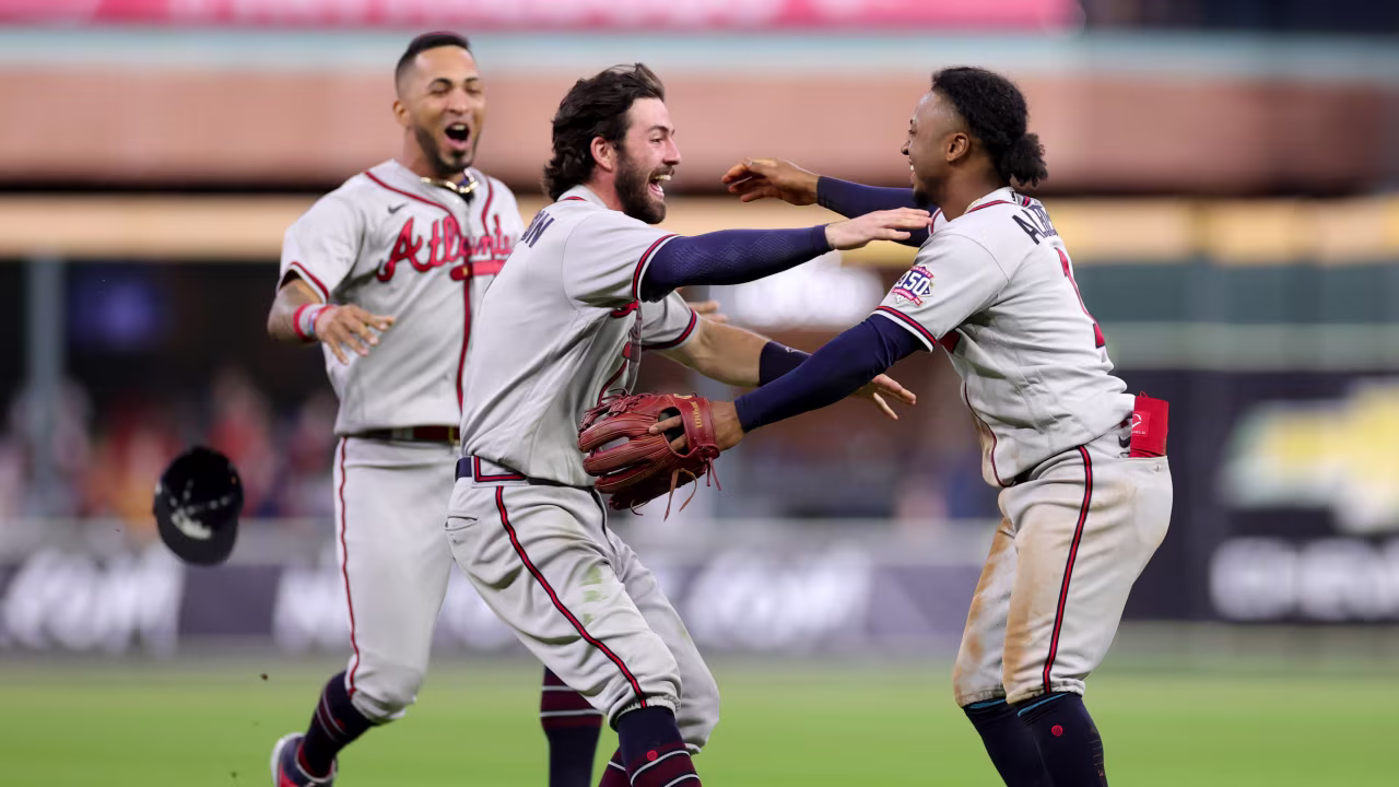 Dansby Swanson, left, and Ozzie Albies, right, of the Braves celebrate the team's victory against the Astros in Game 6 to win the 2021 World Series.