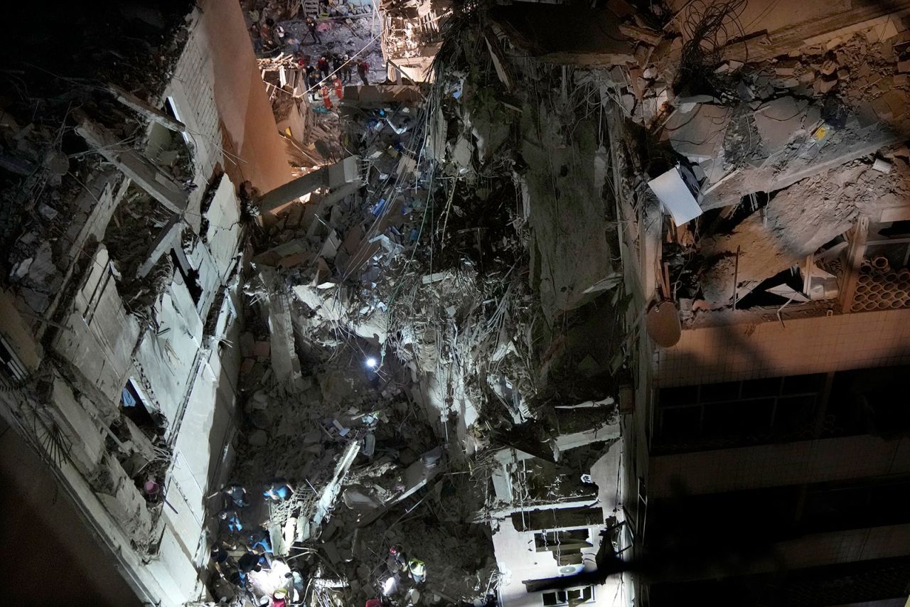 Civil defense workers check for victims between the wreckage of destroyed buildings that were hit by an Israeli airstrike in the southern suburbs of Beirut on Tuesday.