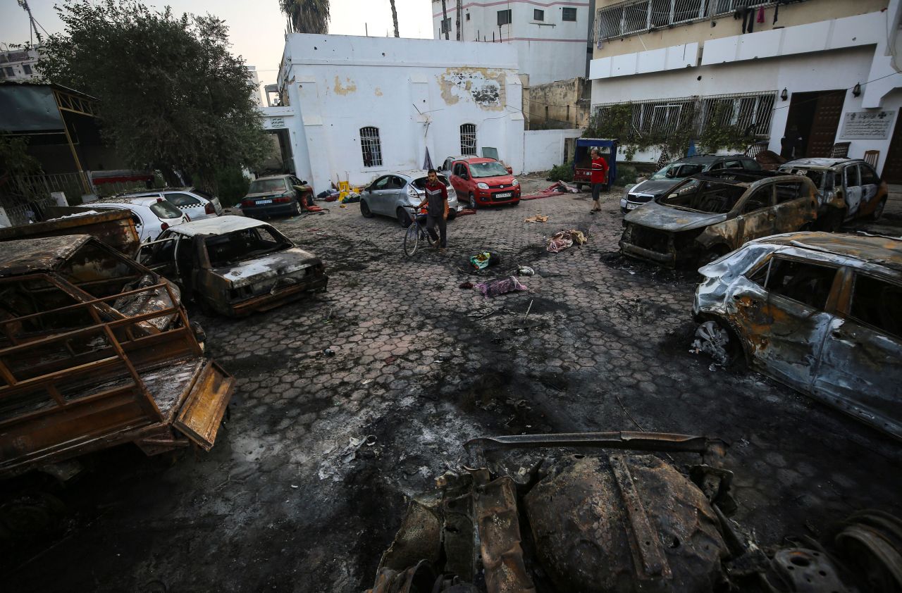 Palestinians assess the aftermath of the blast at Al-Ahli Baptist Hospital in Gaza City on October 18. 