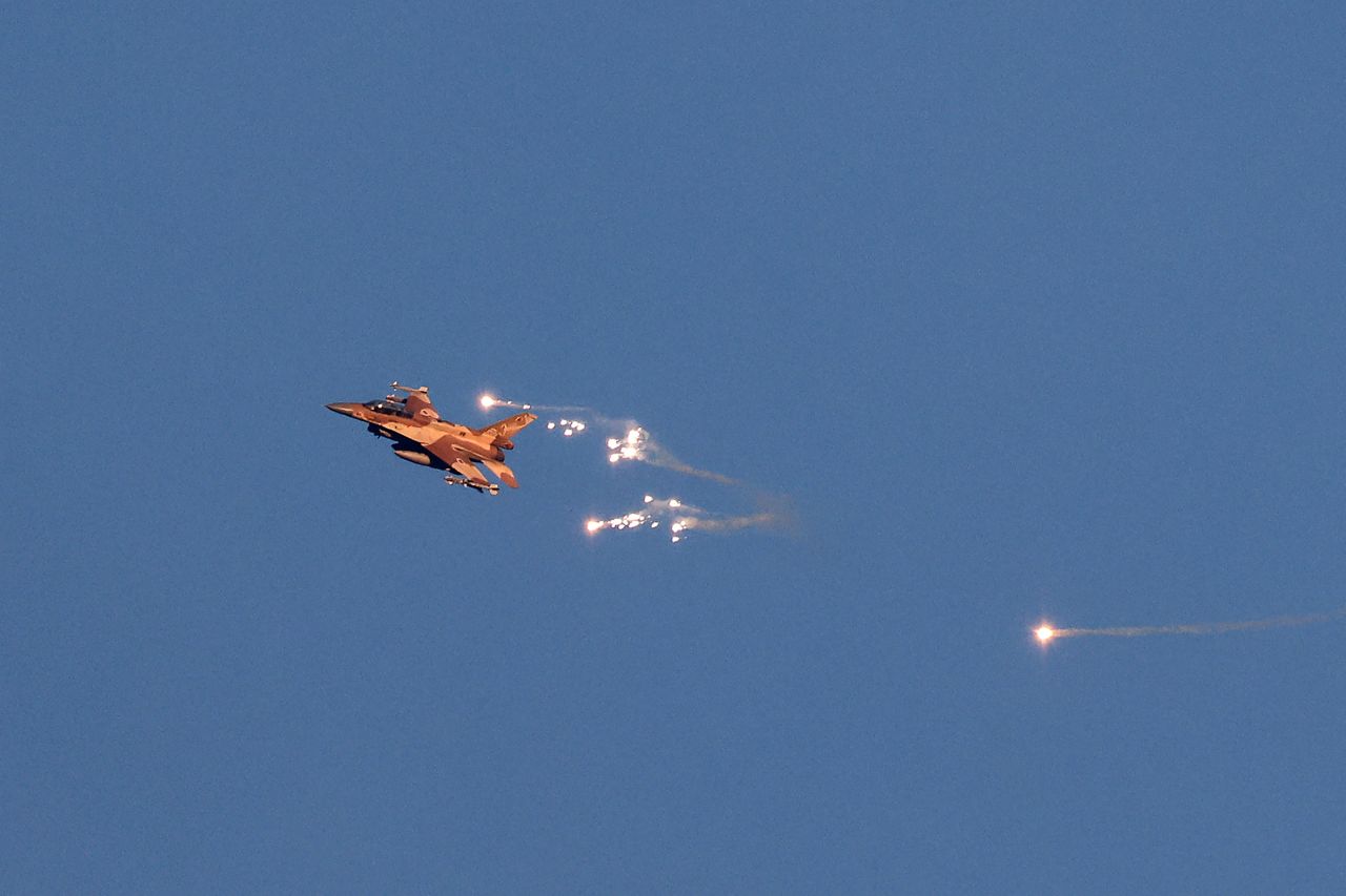 An Israeli Air Force fighter jet fires flares as it flies to intercept a hostile aircraft that launched from Lebanon?on August 25. 