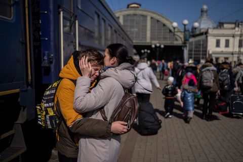 A mother embraces her son after he escaped Mariupol and arrived at the train station in Lviv on Sunday, March 20. 