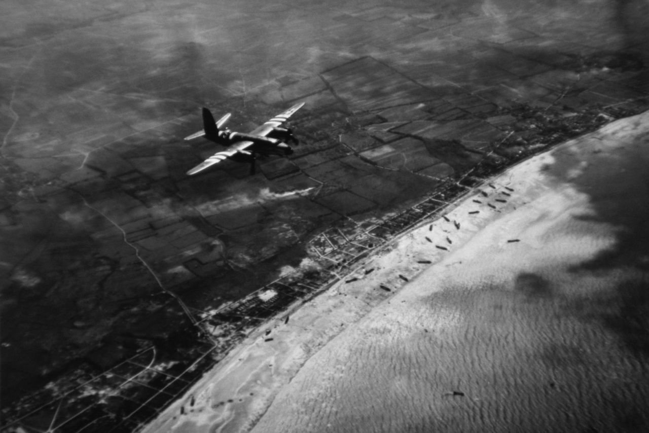 A B-26 from the US Air Force flies over one of the beaches during the invasion.
