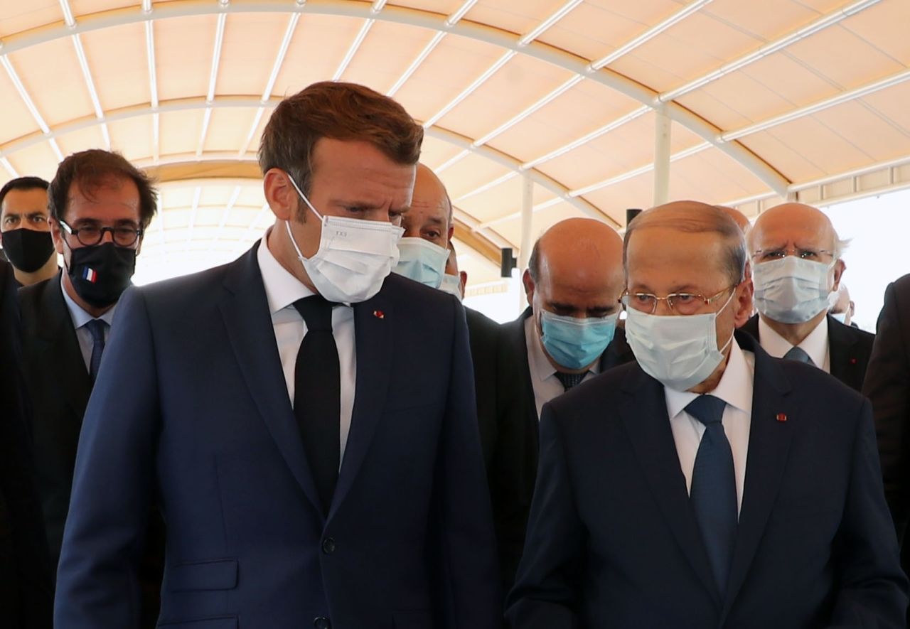 French President Emmanuel Macron, left, walks with Lebanese President Michel Aoun at Rafic Hariri International Airport in Beirut, Lebanon, on August 6.