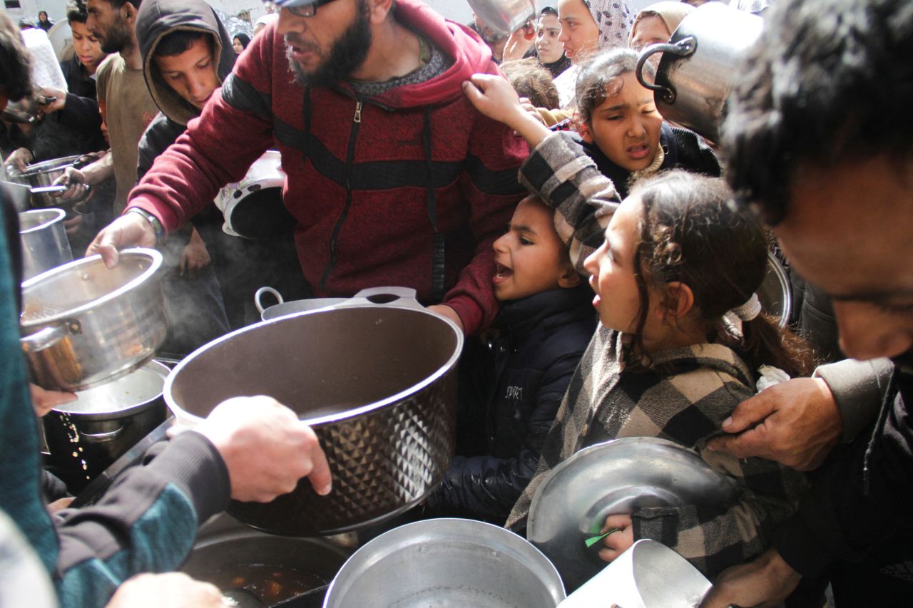 Palestinians gather to receive food in Jabalia, northern Gaza, on March 19. 