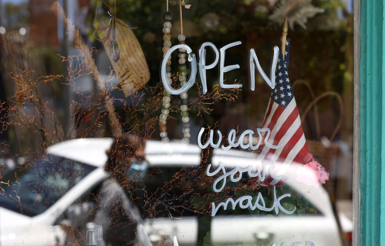 A pedestrian walks by a retail store in San Francisco on June 16.