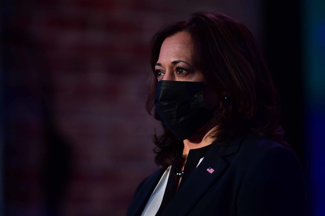 Vice President-elect Kamala Harris listens as President-elect Joe Biden delivers remarks at the Queen Theater in Wilmington, Delaware, on December 28.