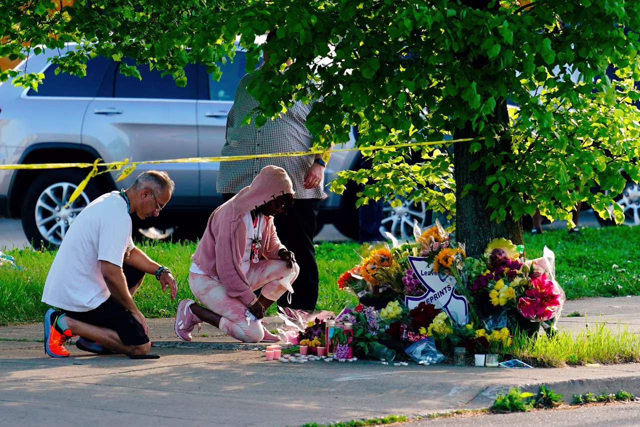 People pay their respects outside the scene of a shooting at a supermarket in Buffalo, New York, Sunday, May 15.