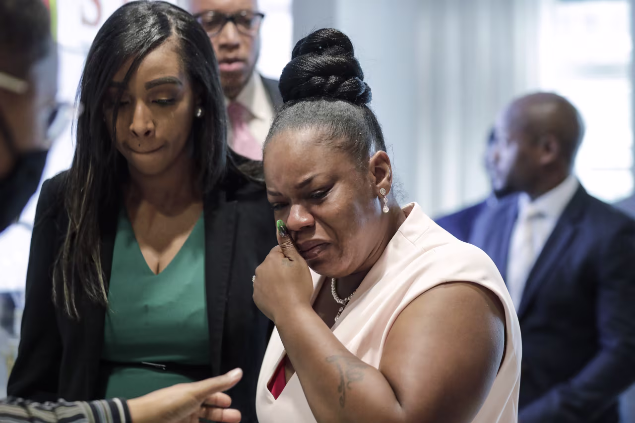 Tomika Miller, center, widow of Rayshard Brooks, cries as she leaves a news conference in Atlanta, Georgia, on Wednesday, June 17. 