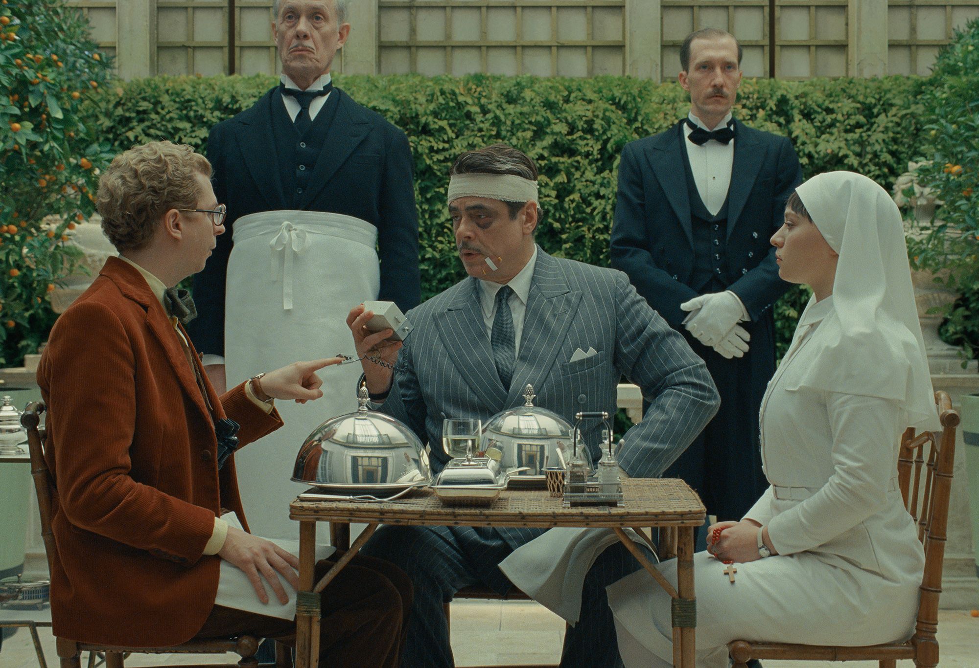 Michael Cera, Benicio Del Toro and Mia Threapleton in a scene from "The Phoenician Scheme," written and directed by Wes Anderson.