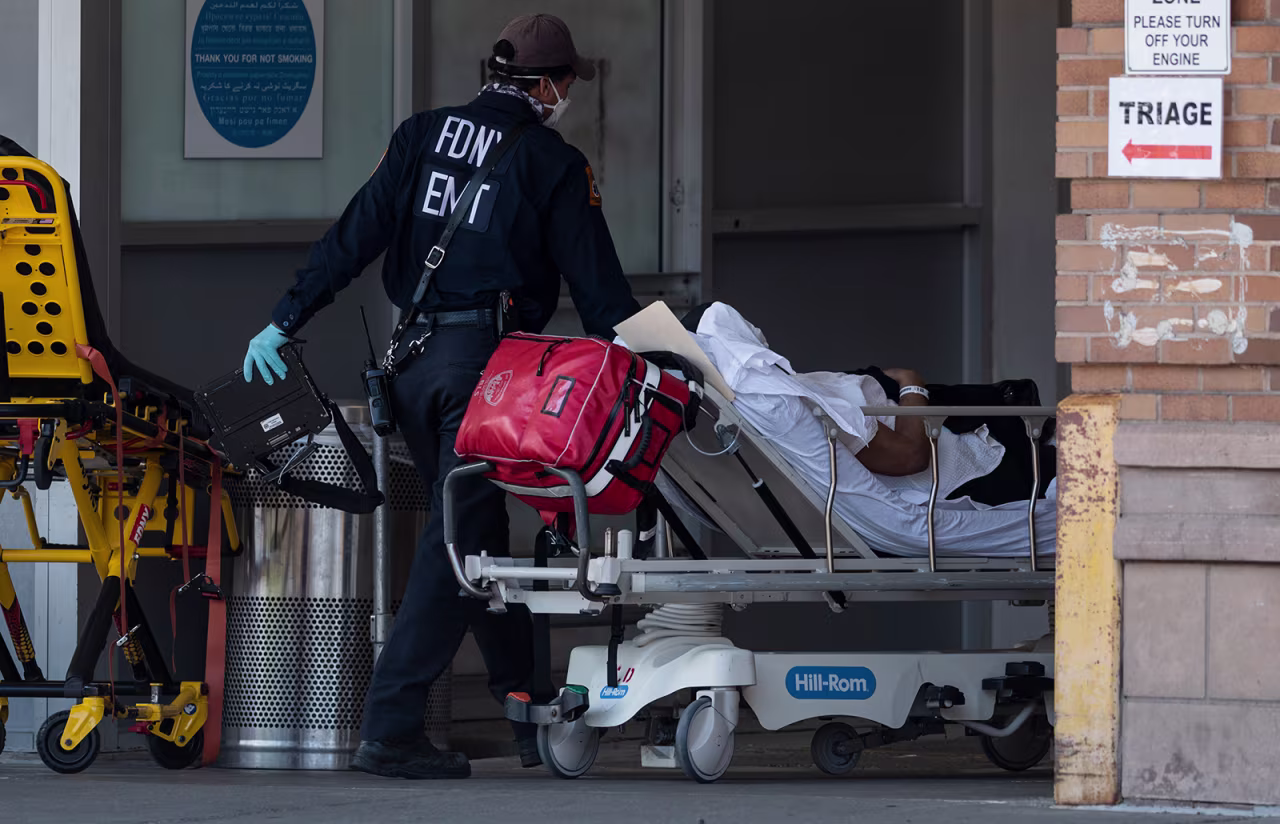 Medical workers transport a patient outside a special COVID-19 illness area at Maimonides Medical Center  in Brooklyn, New York on May 17.