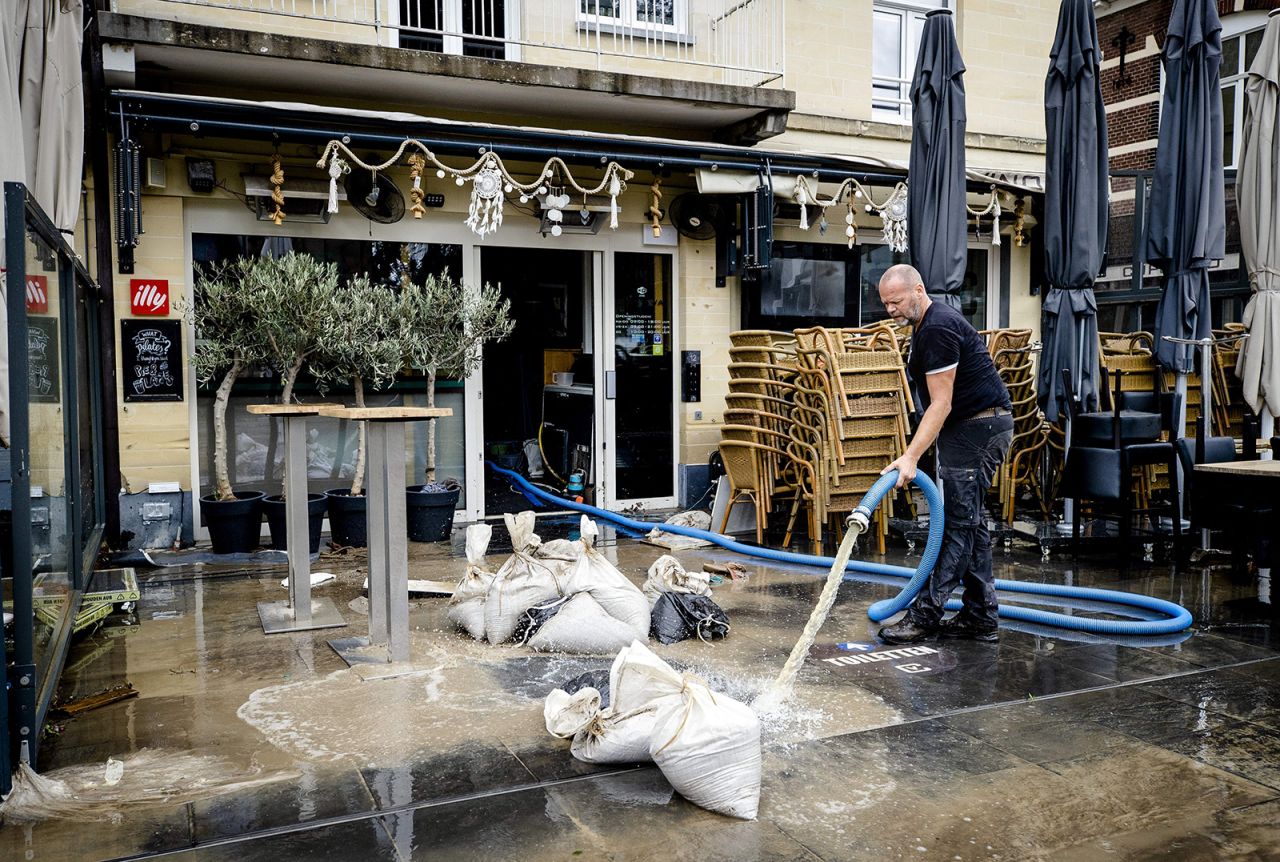 A business owner is pumping water out of his premises, following the damage inflicted by the flooding Geul river in Valkenburg on July 16.