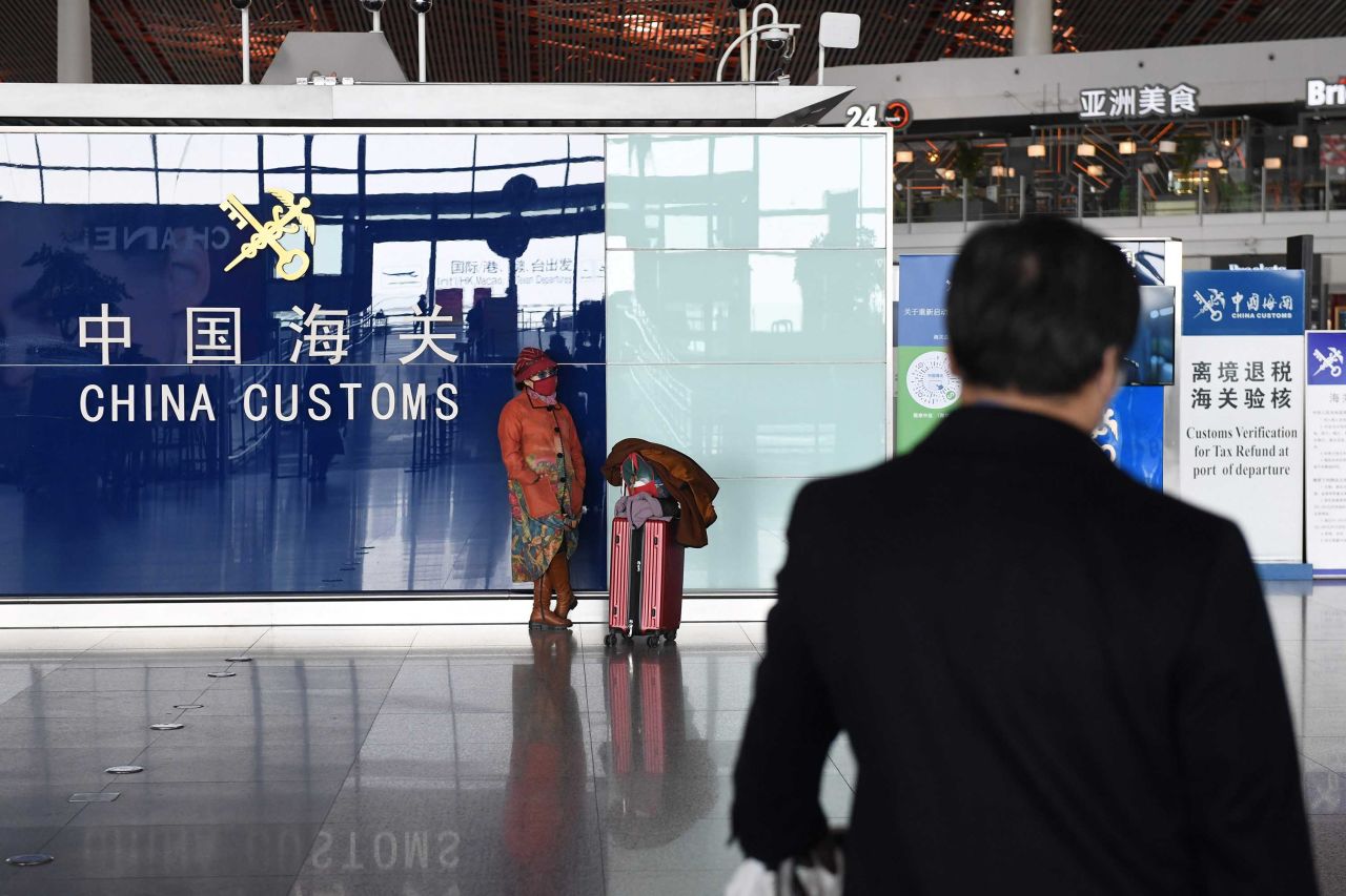 A woman wears a face mask as a preventive measure against the coronavirus as she waits at Beijing Capital Airport on Wednesday.