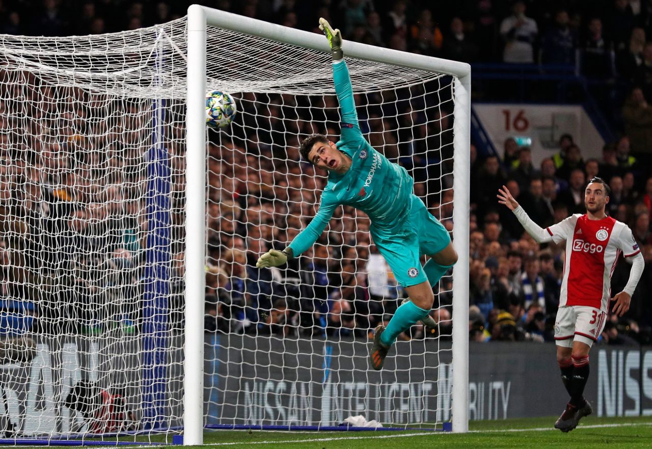 Kepa Arrizabalaga watches on as Hakim Ziyech's free-kick sales over his head.