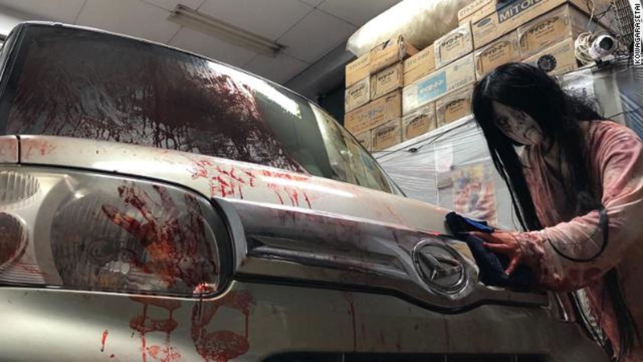 The car is wiped clean of the fake blood at the drive-in haunted house.