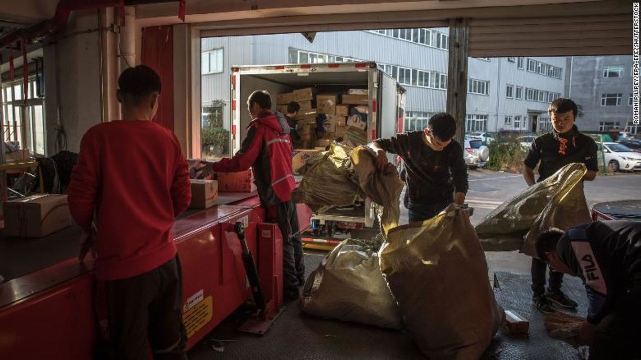 Workers sort packages at a delivery station for JD.com in Beijing in November 2019.