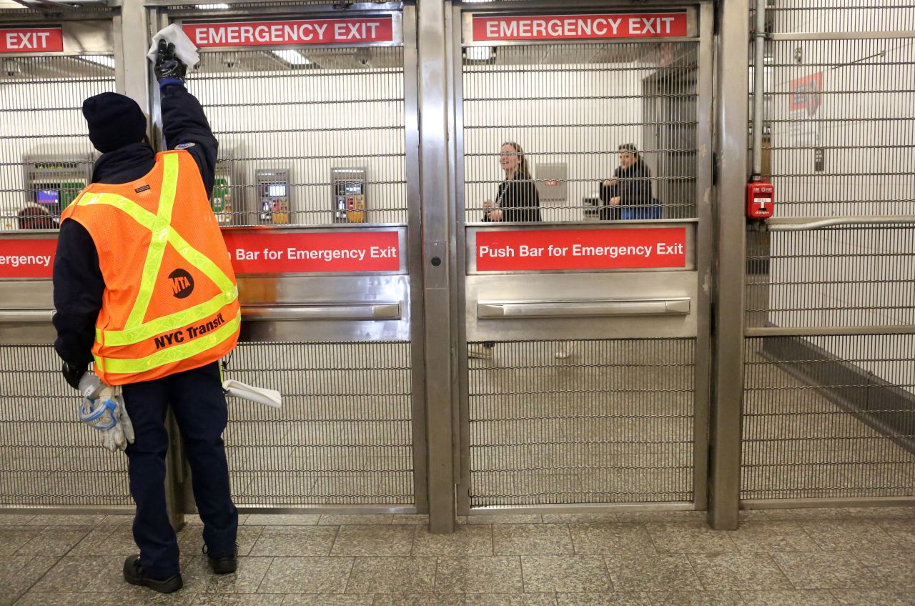 An MTA cleaning staff disinfects the 86th St. Q train station in New York City on March 4.