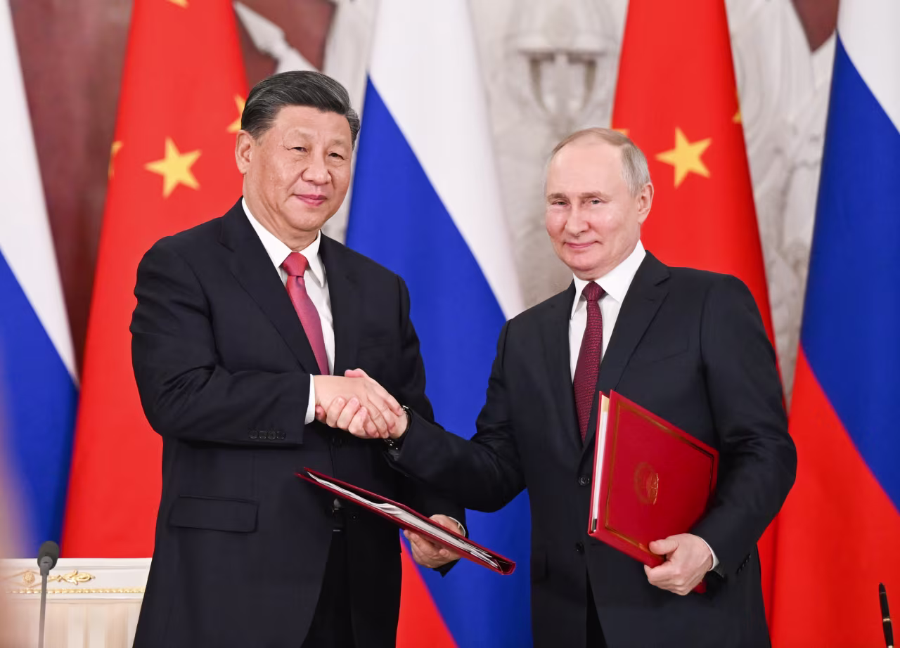 Chinese President Xi Jinping and Russian President Vladimir Putin shake hands during a visit from Xi in Moscow. On Tuesday, Xi held talks with Putin at the Kremlin.