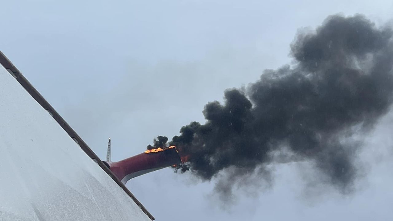 Heath Barnes took this photo of fire and smoke pouring out of an exhaust funnel of the Carnival Freedom cruise ship near Eleuthera Island, Bahamas, on Saturday, March 23.