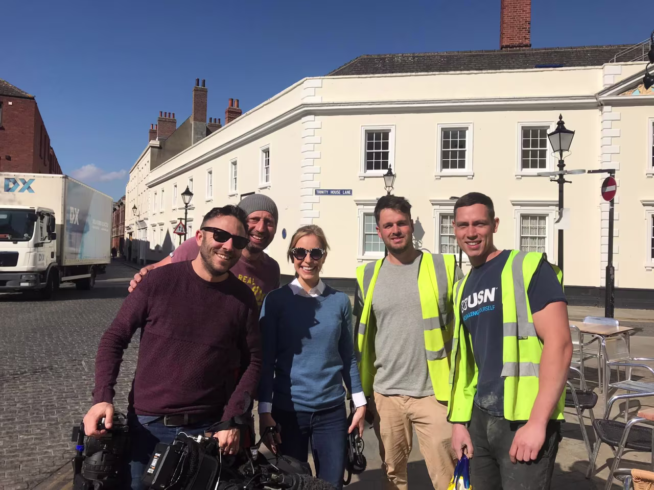 Bricklayers Paul Farley, 42 (2L), Dan Bunby, 27 (2R), and Jamie Galbraith, 32 (R) with CNN's Anna Stewart.