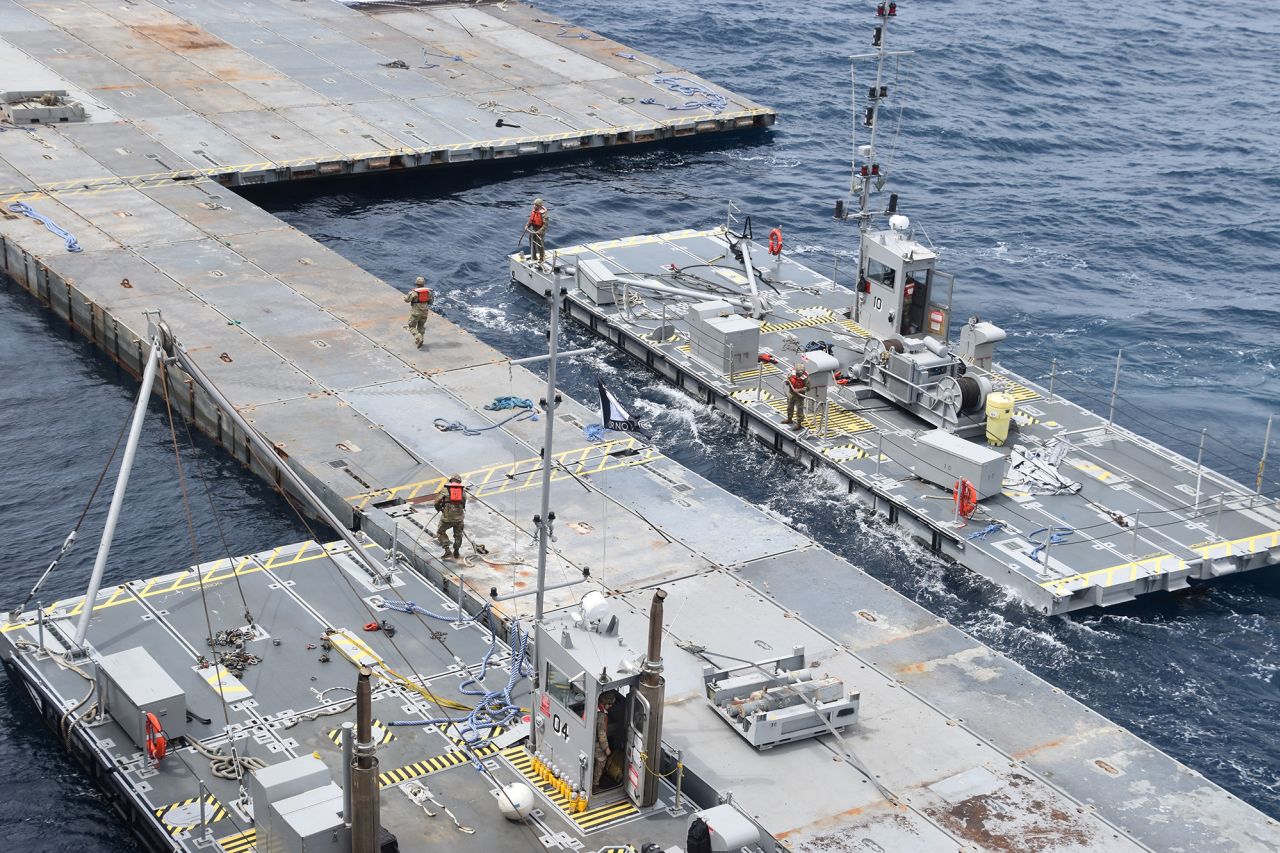 U.S. Army Soldiers assigned to the 7th Transportation Brigade (Expeditionary) and U.S. Navy sailors attached to the MV Roy P. Benavidez assemble the Roll-On, Roll-Off Distribution Facility (RRDF), or floating pier, to assist in the delivery of humanitarian aid to the people of Gaza, in the Mediterranean Sea on April 26.