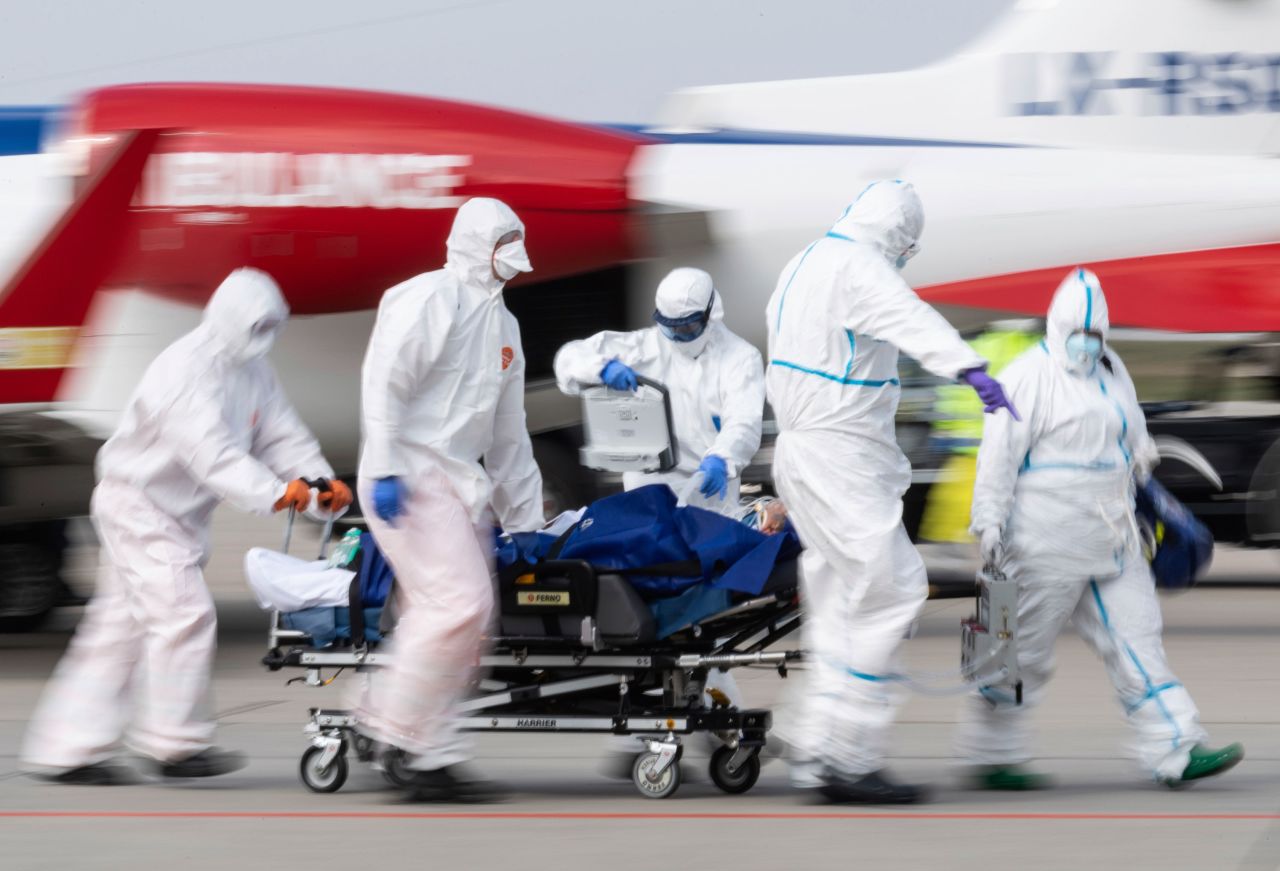A coronavirus patient is transported from an ambulance plane after landing at Dresden International Airport in Dresden, Germany, on April 4.