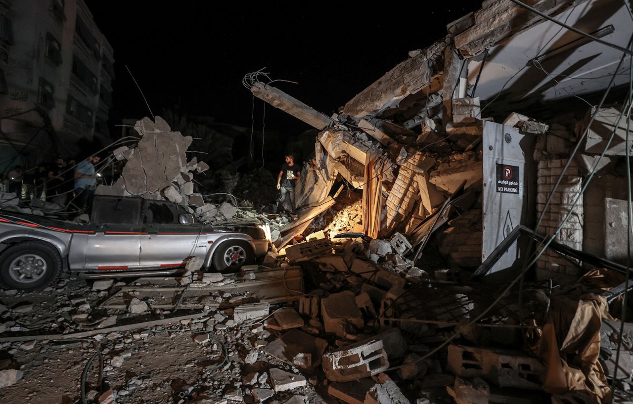 People inspect an area around the Greek Orthodox Church after an Israeli attack in Gaza City, on October 20.