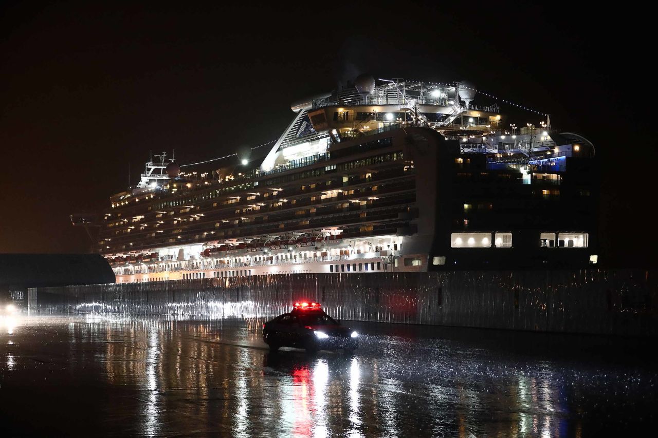 A police car drives past the Diamond Princess cruise ship at Yokohama port on Sunday.