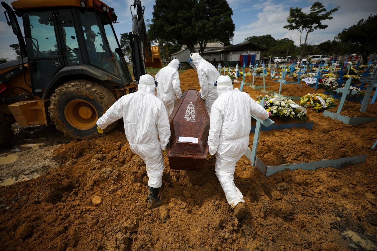 Cemetery workers in Manaus, Brazil, carry the coffin of a person said to have died of Covid-19, on January 15.