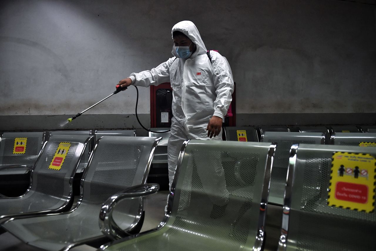 A man sprays disinfectant on seats inside a waiting room at Mo Chit Bus Terminal in Bangkok on January 6.