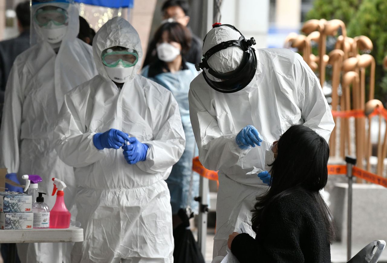 Medical staff take samples from workers at a building where multiple people were confirmed to have coronavirus in Seoul, South Korea on March 10. 