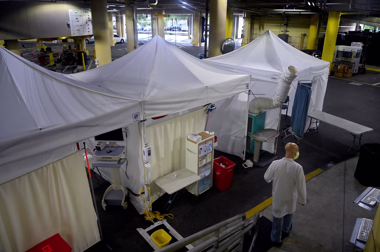Dr. Davis Wein, an emergency medicine specialist walks, in the parking garage that was turned into a series of Covid-19 test tents at Tampa General Hospital in Florida on August 19.