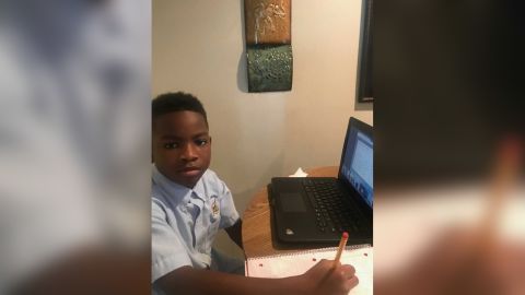 Ka Mauri Harrison, 9, pictured in his home participating in virtual learning. 