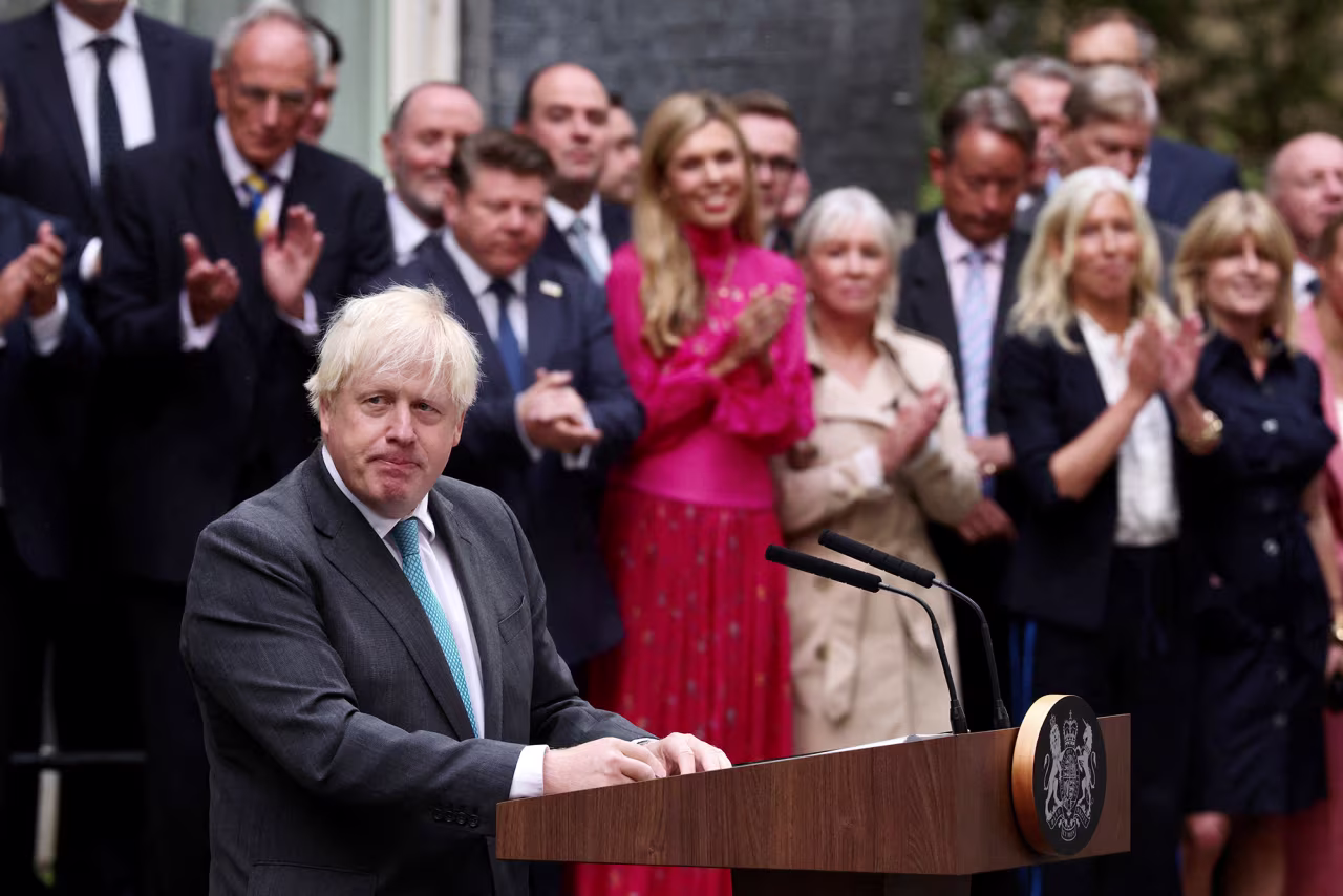Boris Johnson leaves Downing Street, on his last day in office as British prime minister watched by his wife Carrie, in London, England, on September 6.