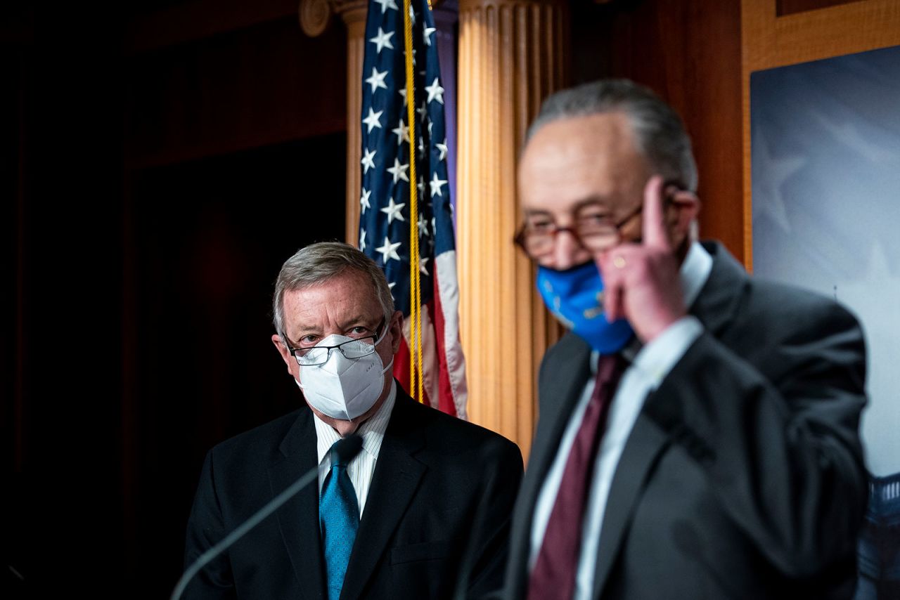 From left, Senate Majority Whip Dick Durbin listens to Senate Majority Leader Chuck Schumer speak at a news conference on February 23.