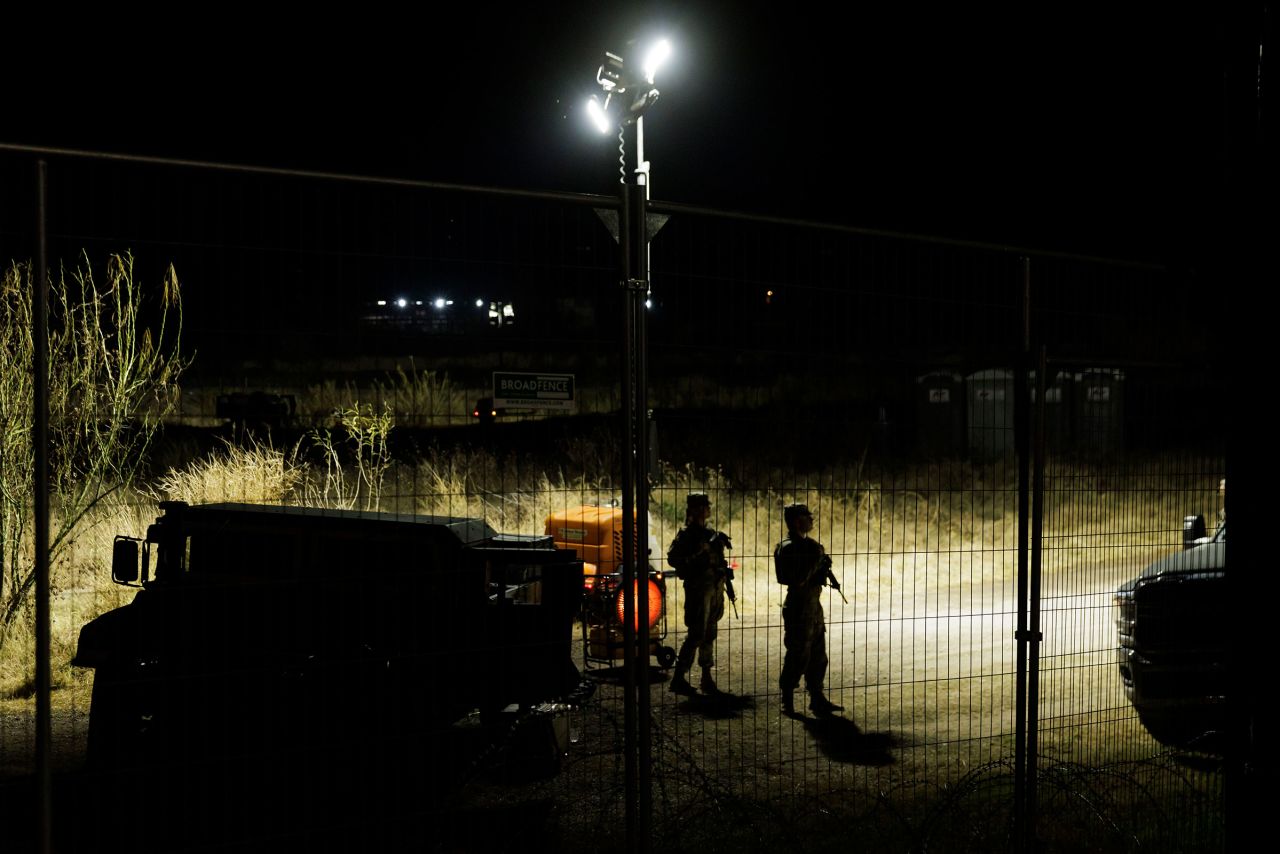 National Guard soldiers stand near a gas heater at Shelby Park on February 3 in Eagle Pass, Texas.