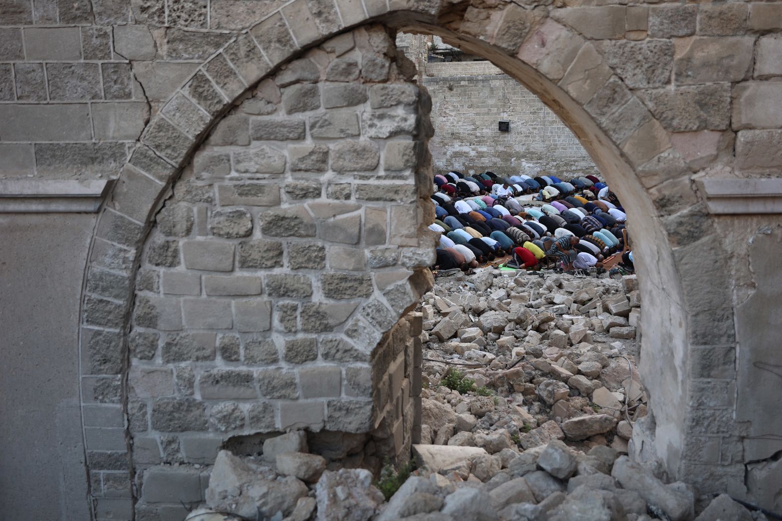 Palestinians perform Eid al-Adha morning prayers in the courtyard of Gaza City’s historic Omari Mosque on June 16. The mosque was damaged by Israeli bombardment in Gaza.