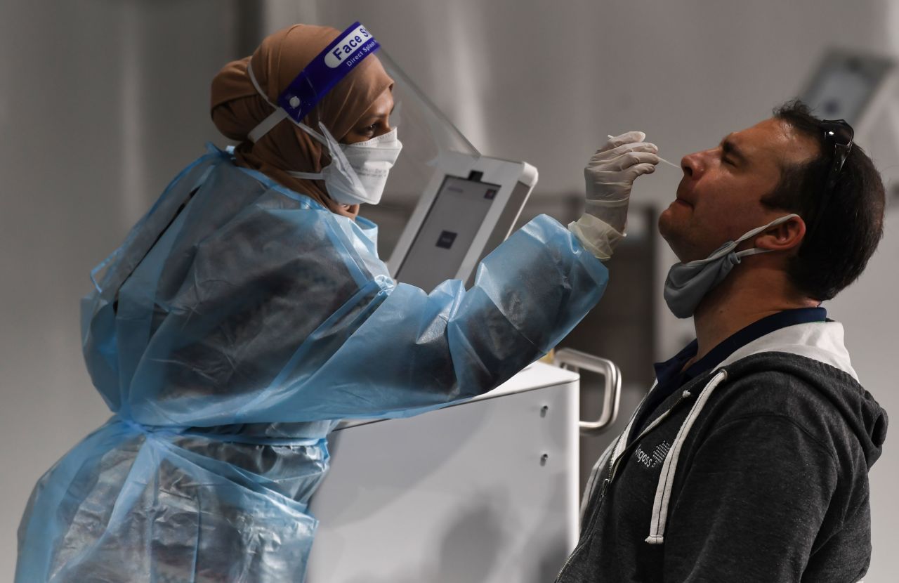 A man undergoes a COVID-19 test at the pre-departure area of Sydney International Airport on November 28, 2021.      