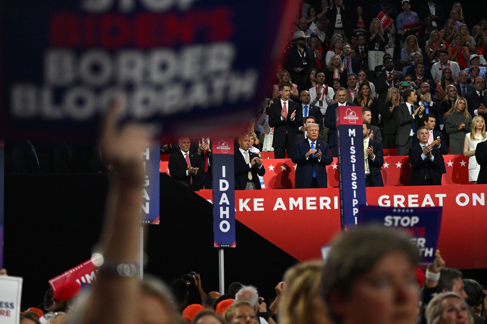 Trump claps while attending the convention on Tuesday.