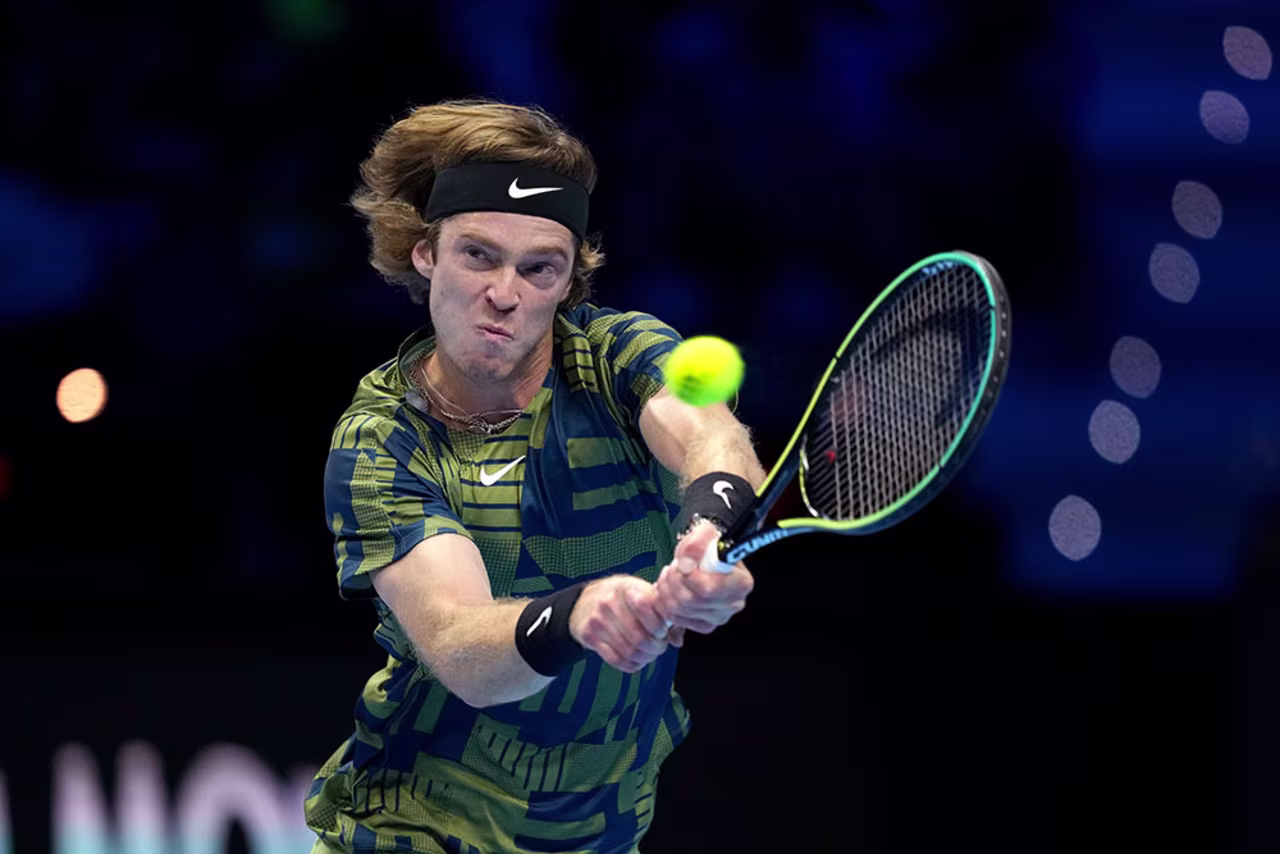 Rublev returns the ball to Daniil Medvedev during their singles tennis match at the ATP World Tour Finals, in Turin, Italy, Monday, November 14.