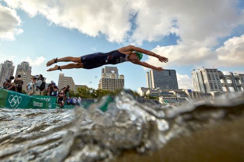 America's Kevin McDowell dives into the water to start the individual triathlon on July 26. 