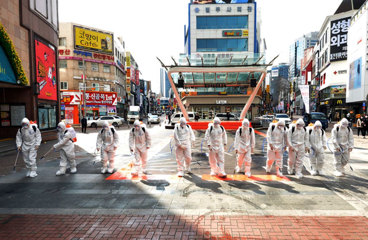 South Korean army soldiers wearing protective suits spray disinfectant to prevent the spread of coronavirus on a street in Daegu, South Korea, on Thursday, February 27.