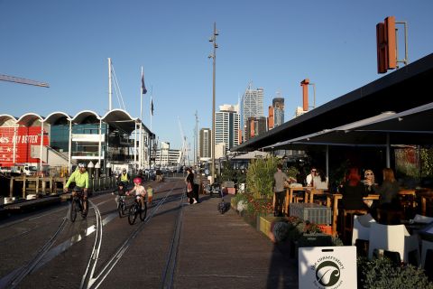 People enjoy socializing with a drink outside at the bars in Auckland's Wynard Quarter on May 21 in Auckland, New Zealand. 