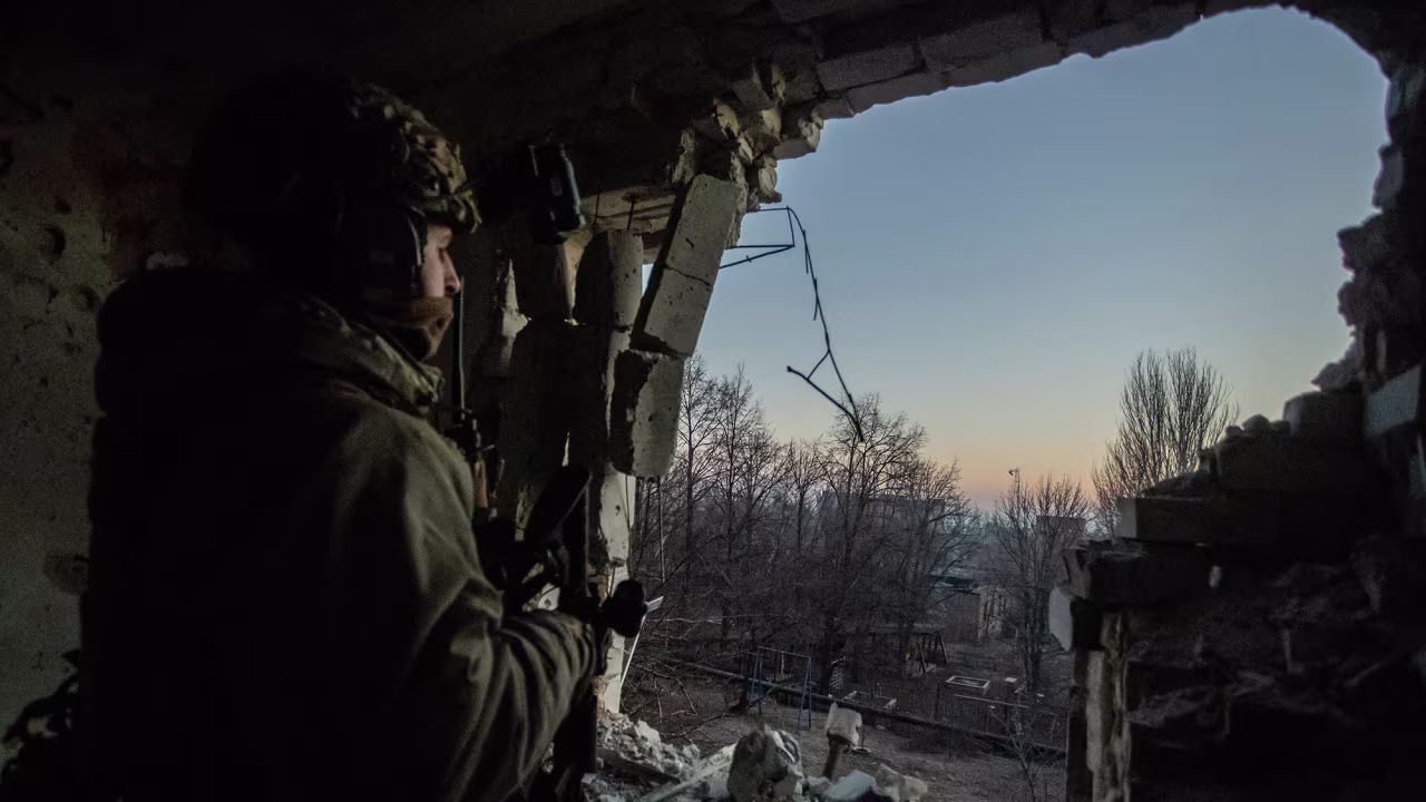 A Ukrainian serviceman looks out into Bakhmut amid Russia's attack on January 27.