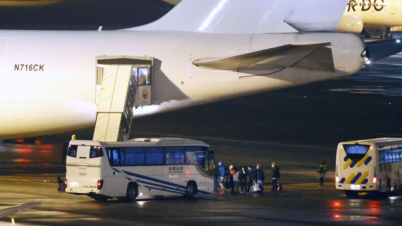 American citizens evacuated from the coronavirus-hit Diamond Princess cruise ship that has been kept in quarantine in Yokohama board a U.S. government-chartered plane at Tokyo's Haneda airport on Monday, February 17.
